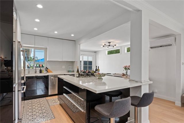 a kitchen with a sink and chairs