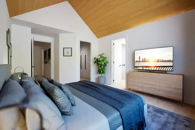 a bedroom with a bed and a chandelier