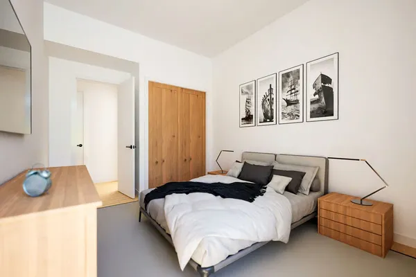 a bedroom with a bed and a couch