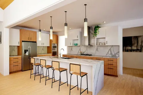 a kitchen with stainless steel appliances kitchen island granite countertop a refrigerator a stove and a sink with wooden floor