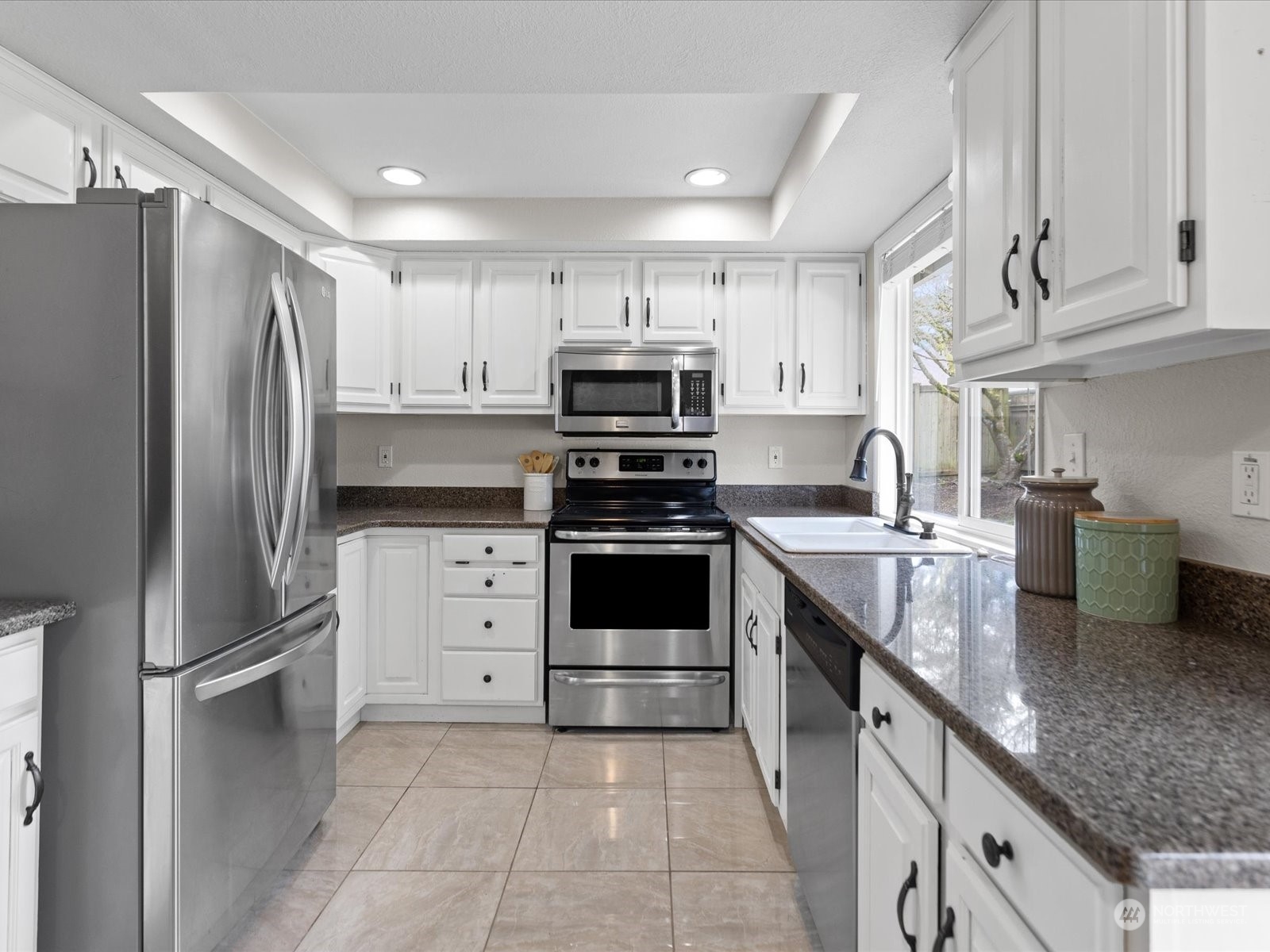 22210 West 2nd Avenue Bothell, WA 98021 - Photo 6 of 24 a kitchen with granite countertop a refrigerator stove and sink
