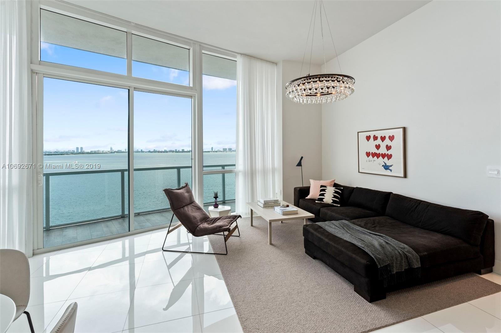 665 Northeast 25th Street, Unit 802 Miami, FL 33137 - Photo 2 of 24 a living room with furniture and a window