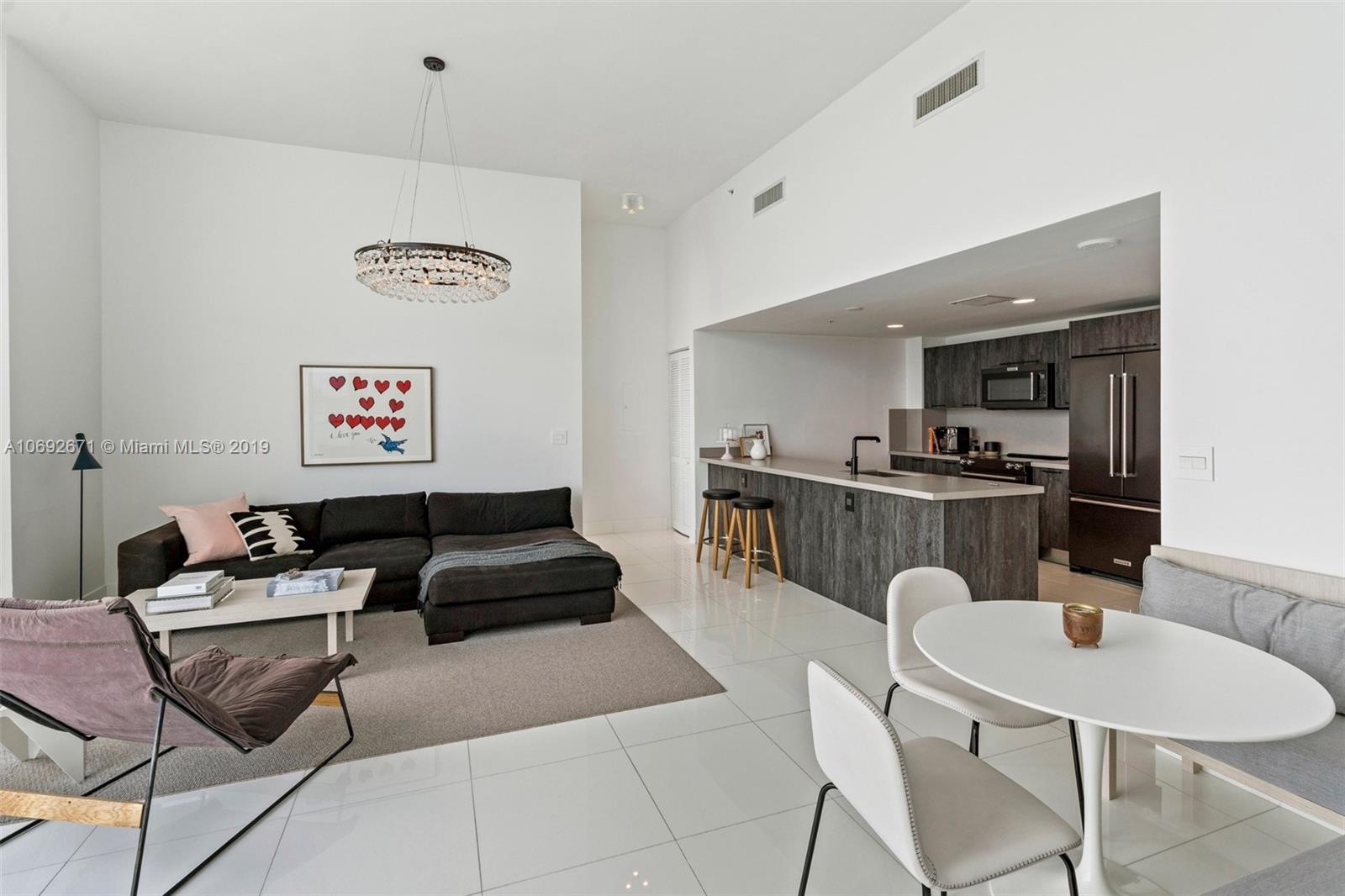 665 Northeast 25th Street, Unit 802 Miami, FL 33137 - Photo 5 of 24 a living room with furniture kitchen view and a window