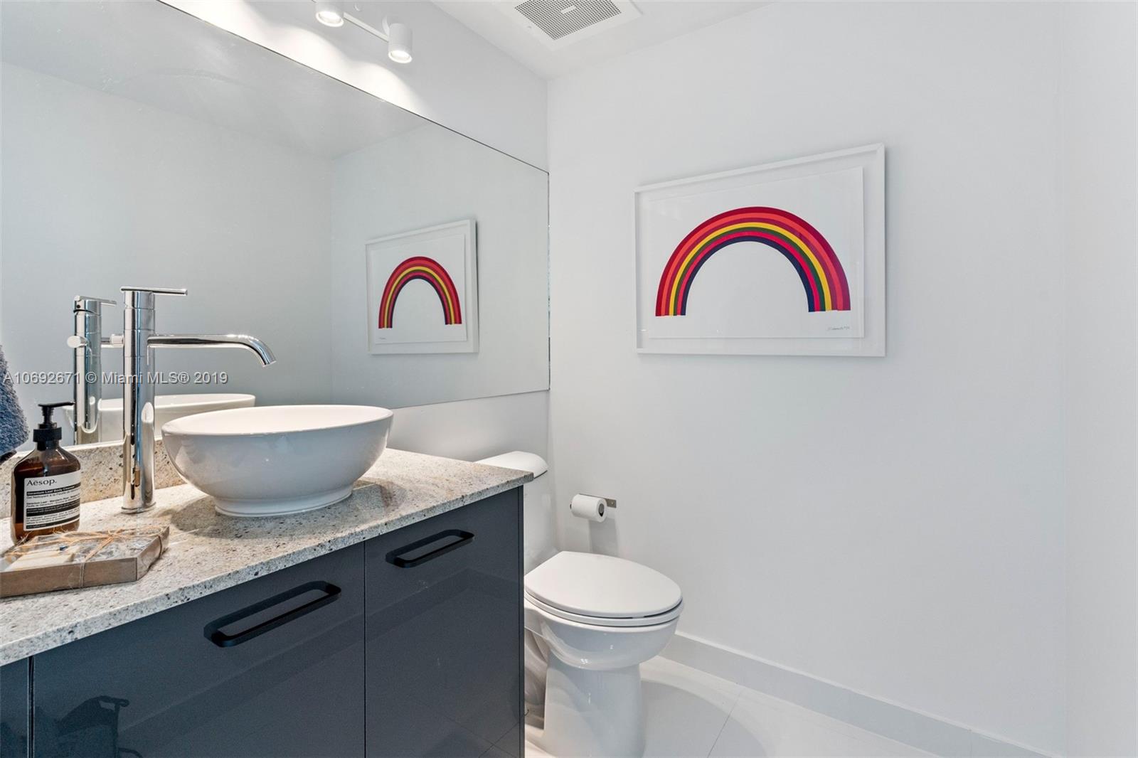 665 Northeast 25th Street, Unit 802 Miami, FL 33137 - Photo 9 of 24 a bathroom with a toilet and a sink