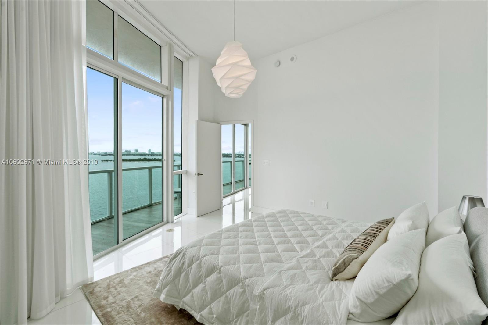 665 Northeast 25th Street, Unit 802 Miami, FL 33137 - Photo 10 of 24 a bedroom with a bed and a window