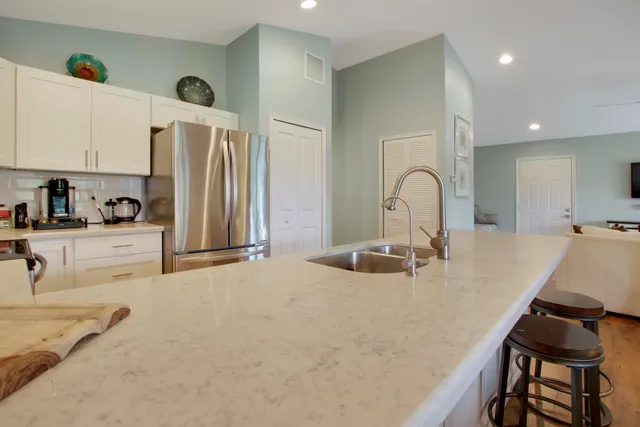 a kitchen with sink refrigerator and stove