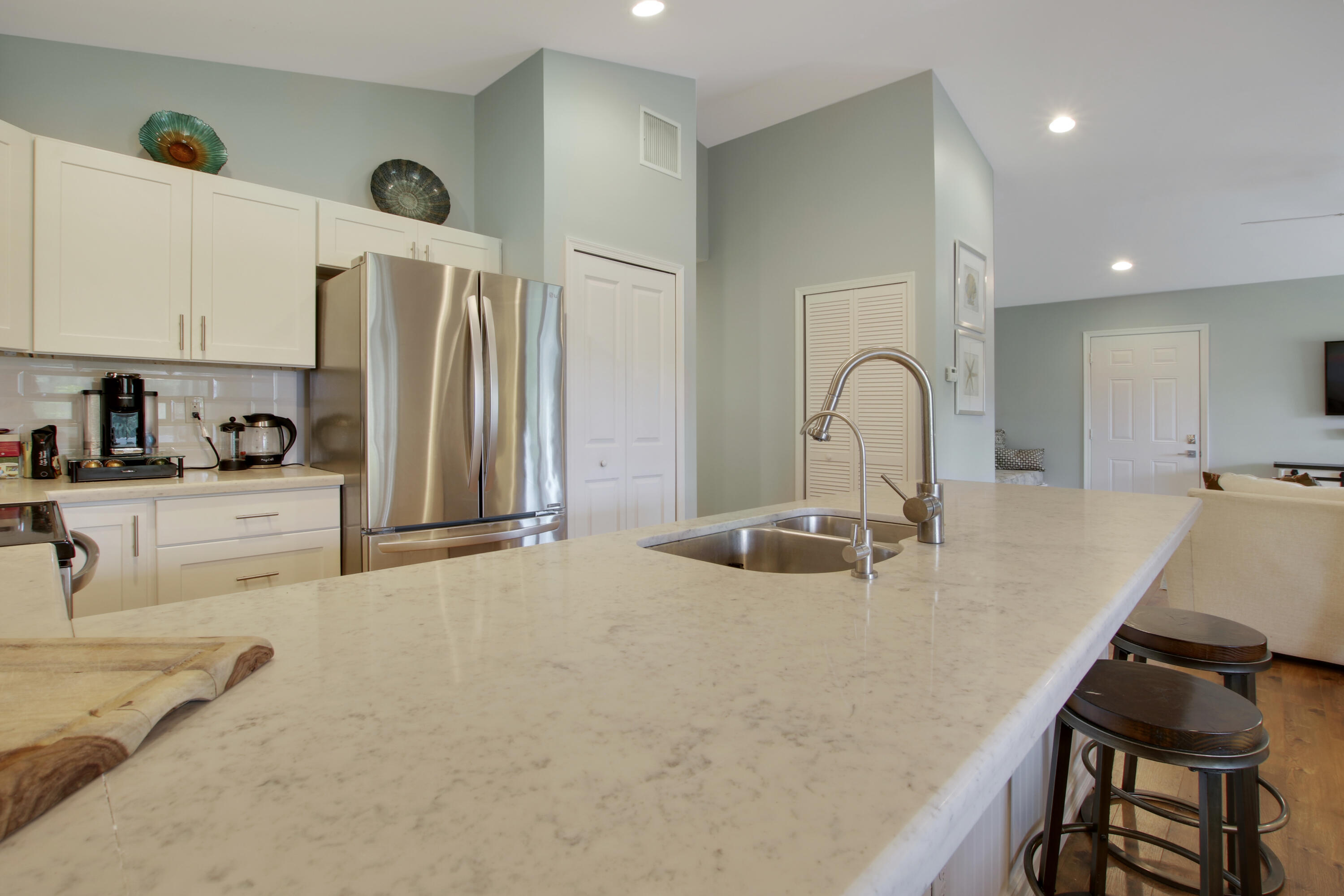 9155 Southeast Athena Street Hobe Sound, FL 33455 - Photo 12 of 25 a kitchen with sink refrigerator and stove