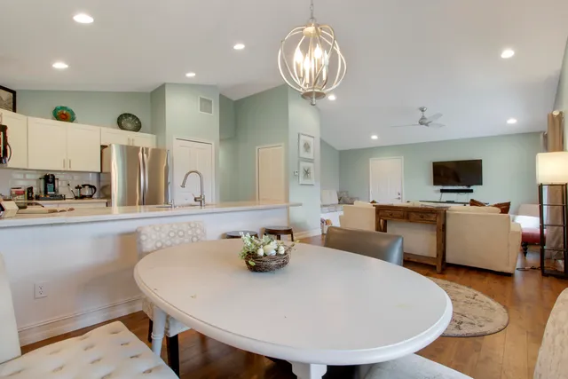 a large kitchen with a table and chairs