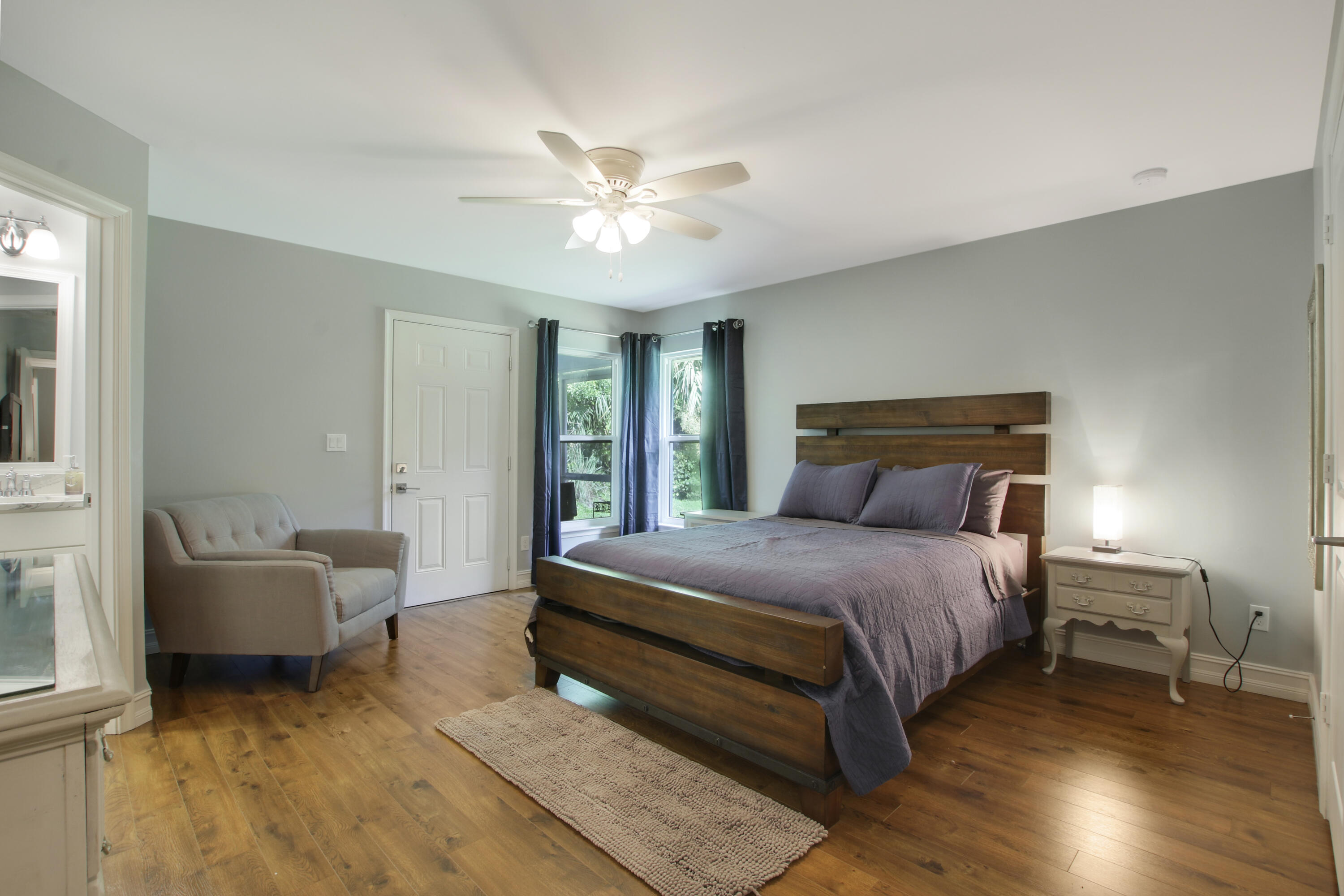 9155 Southeast Athena Street Hobe Sound, FL 33455 - Photo 15 of 25 a bedroom with a bed and a couch