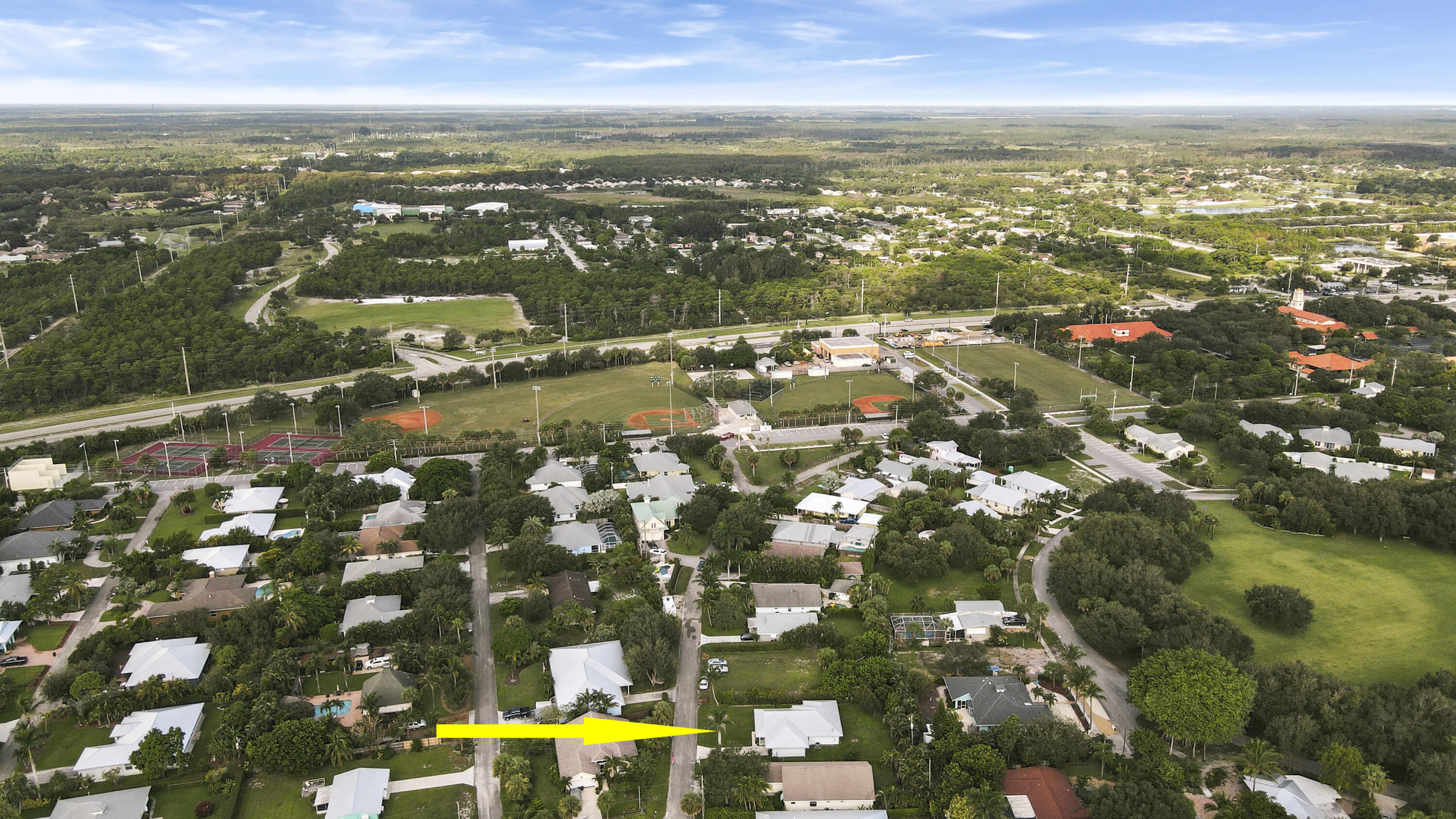 9155 Southeast Athena Street Hobe Sound, FL 33455 - Photo 23 of 25 an aerial view of residential building with parking space