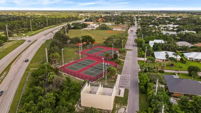 an aerial view of residential houses with outdoor space and river