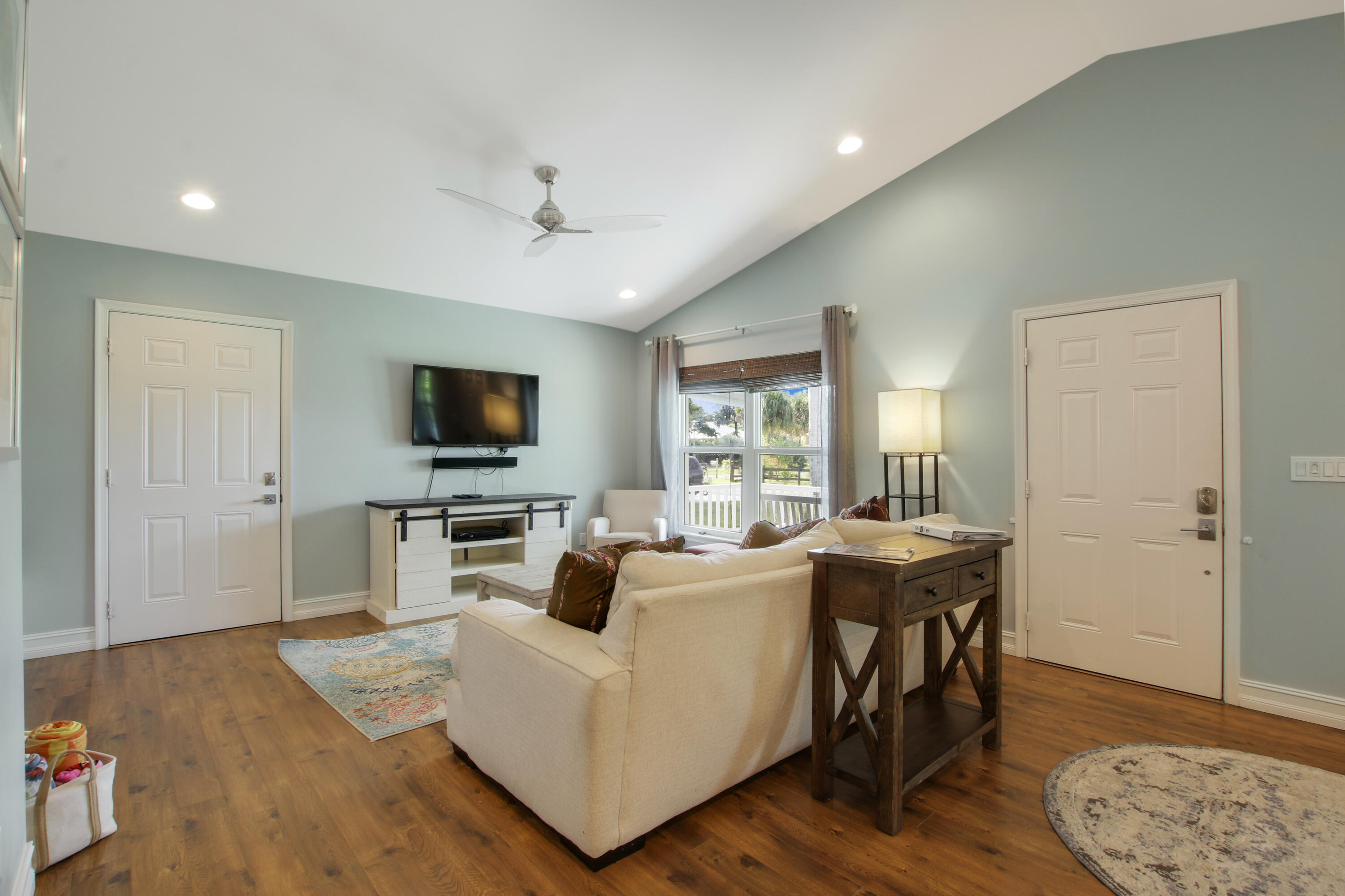 9155 Southeast Athena Street Hobe Sound, FL 33455 - Photo 5 of 25 a living room with furniture and a flat screen tv