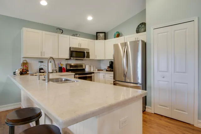 a kitchen with stainless steel appliances a refrigerator stove microwave and sink