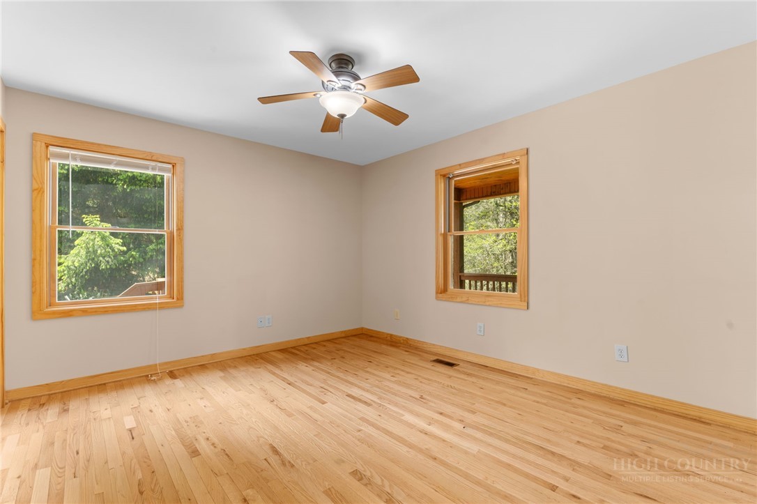 148 Woodby Ridge Road Vilas, NC 28692 - Photo 24 of 33 a view of an empty room with wooden floor and a window