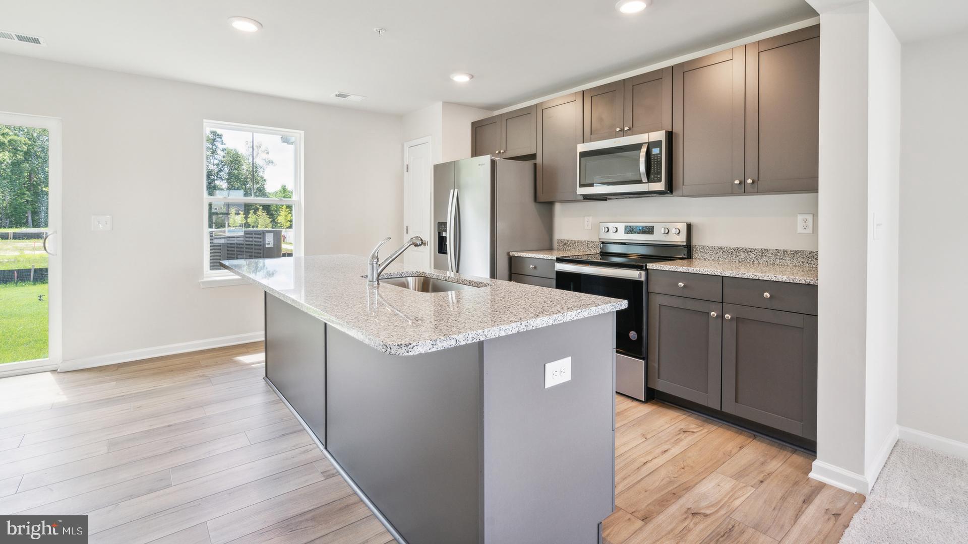 601 Widgeon Way Cambridge, MD 21613 - Photo 2 of 17 a kitchen with sink a microwave and refrigerator