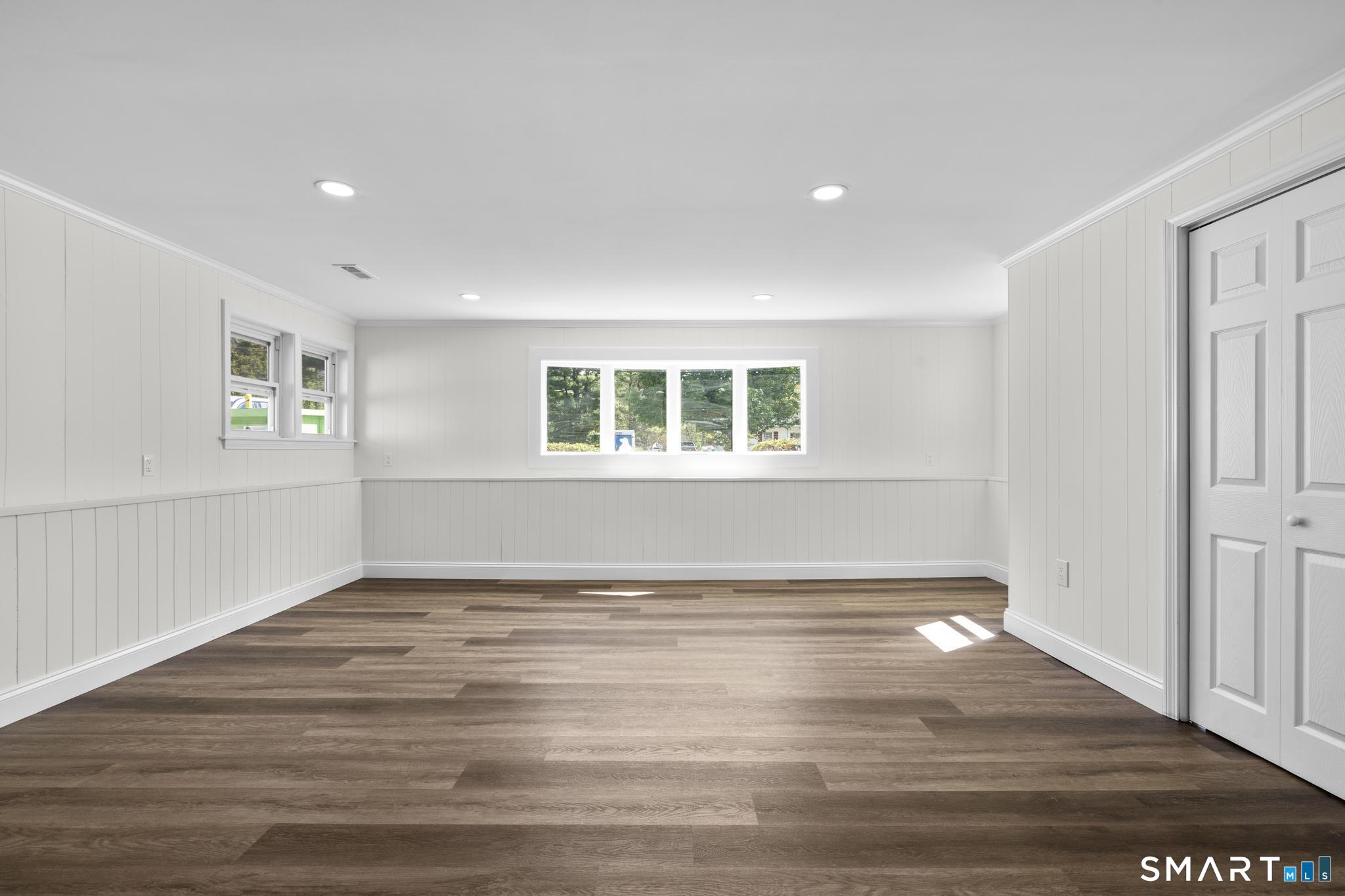 26 Quaddick Town Farm Road Thompson, CT 06277 - Photo 23 of 32 a view of an empty room with wooden floor and a window