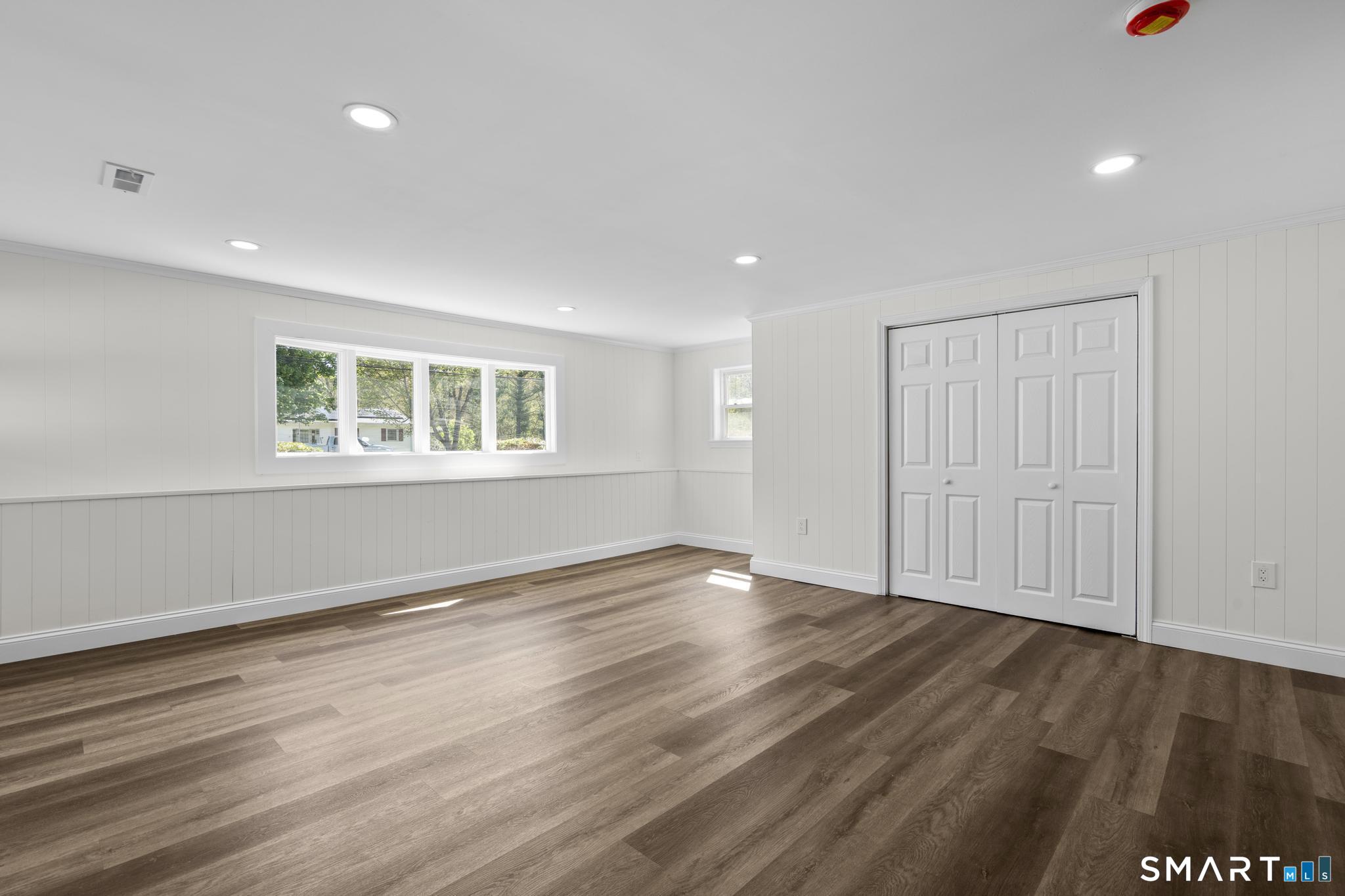 26 Quaddick Town Farm Road Thompson, CT 06277 - Photo 24 of 32 a view of an empty room with wooden floor and a window