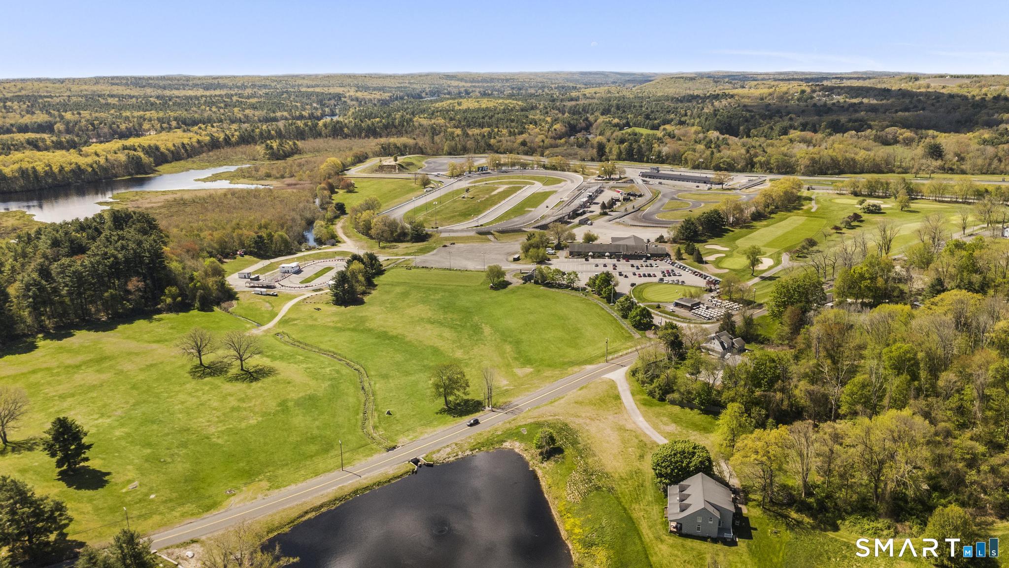 26 Quaddick Town Farm Road Thompson, CT 06277 - Photo 32 of 32 an aerial view of residential houses with outdoor space