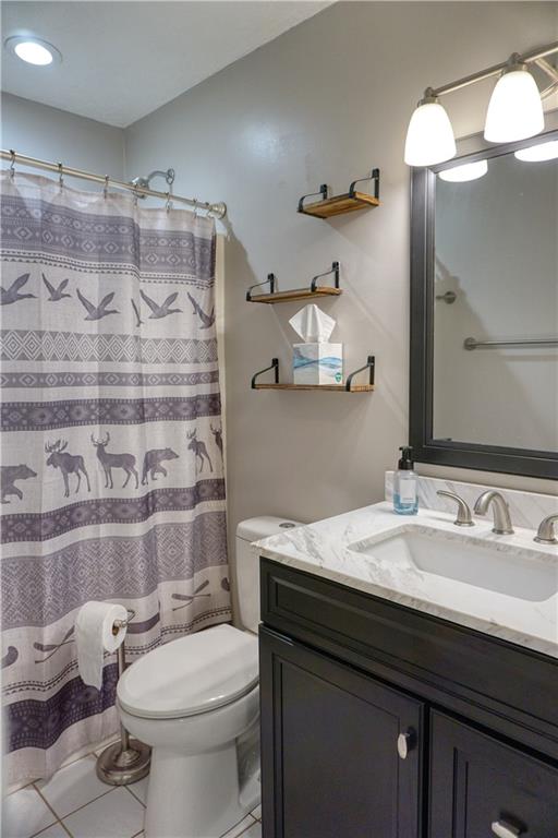 403 Meridian Road Butler, PA 16001 - Photo 14 of 25 a bathroom with a sink a toilet and shower curtain