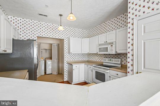 9511 Kingscroft Terrace, Unit 9511F Perry Hall, MD 21128 - Photo 19 of 38 a kitchen with stainless steel appliances granite countertop a stove a sink and a refrigerator