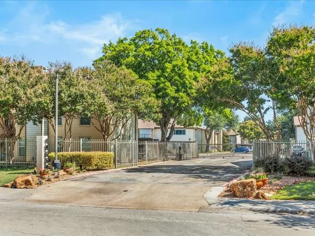 a view of a house with a tree in front