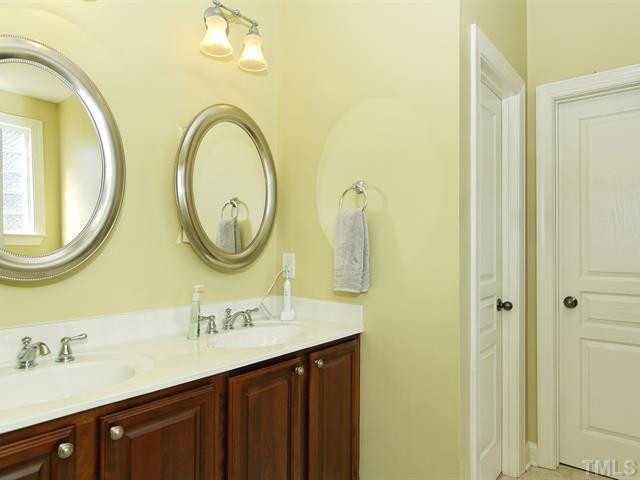13006 Edsel Drive Raleigh, NC 27613 - Photo 13 of 25 Master bath with dual vanity and oval mirrors. Large walk-in closet. Master Bath/Spa