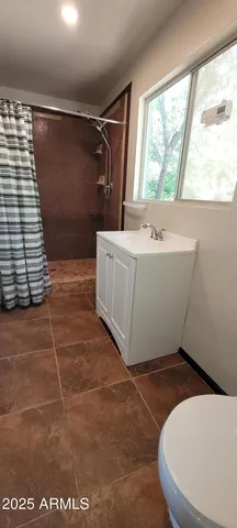 a white bath tub sitting in a bathroom next to a window