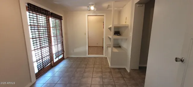 a view of entryway with window and cabinet