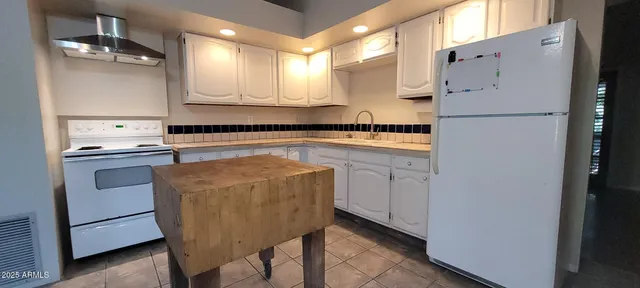 a kitchen with cabinets and stainless steel appliances