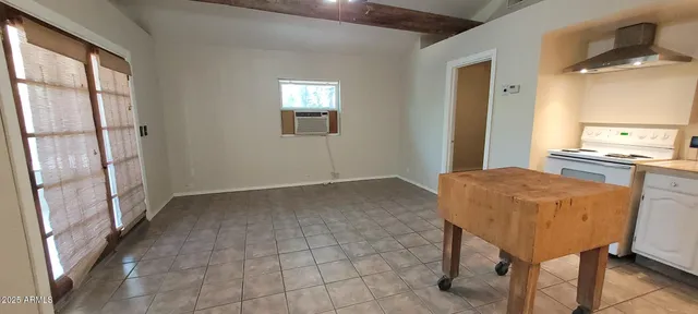 a view of a kitchen and an empty room