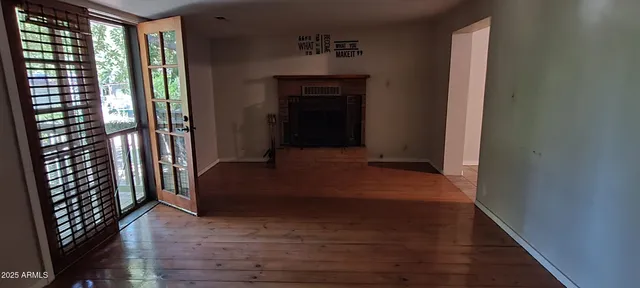 a hallway with sliding door and wooden floor