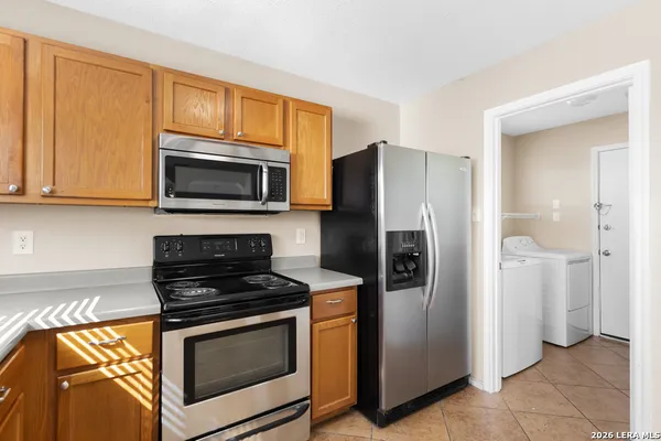 a kitchen with stainless steel appliances granite countertop a stove microwave and refrigerator