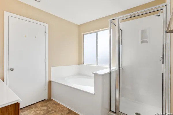 a bathroom with a bathtub and a shower