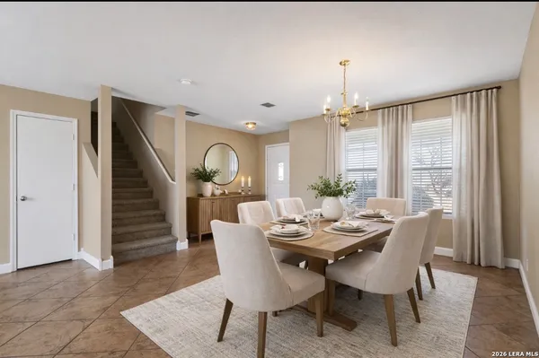 a dining room with furniture entryway and wooden floor