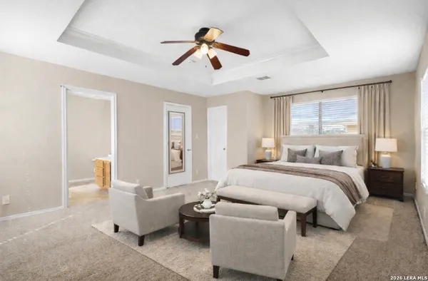 a spacious bedroom with a bed and a couch