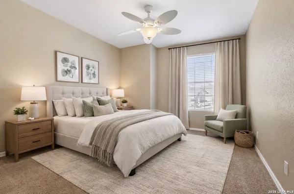 a spacious bedroom with a bed and a couch