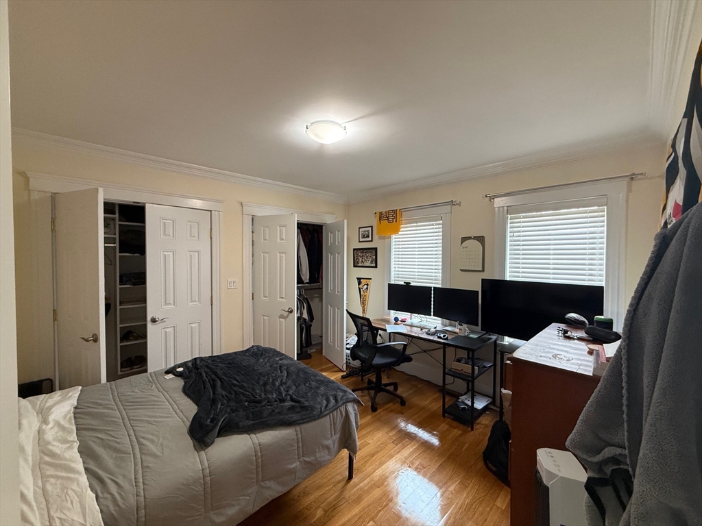 72 Bennett Street, Unit 72 Boston, MA 02135 - Photo 8 of 17 a bedroom with a bed and wooden floor