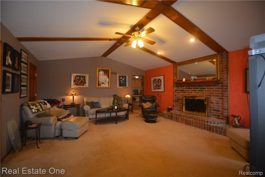 706 Snowmass Drive Rochester, MI 48309 - Photo 5 of 25 Nestle down in to this large beautiful great room with brick fireplace and vaulted ceiling.