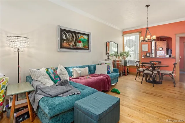 a living room with furniture a rug and a window