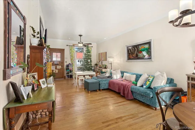 a living room with furniture window and wooden floor