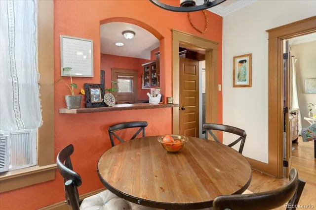 a view of a dining room with furniture and a window