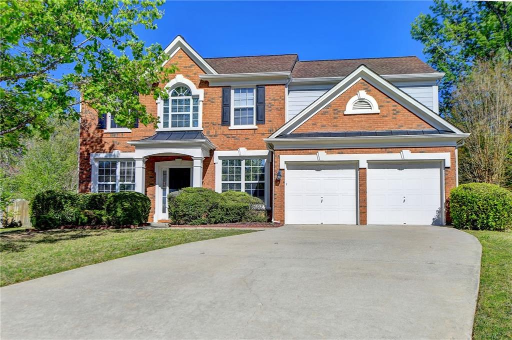 180 Gaines Oak Way Suwanee, GA 30024 - Photo 1 of 1 a front view of a house with a yard and trees