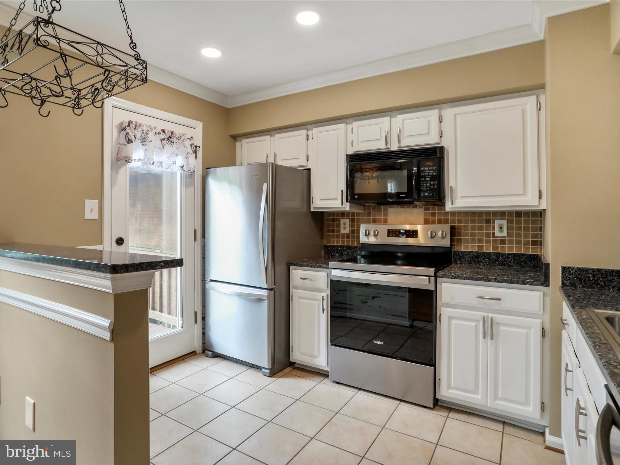 6910 Compton Valley Court Centreville, VA 20121 - Photo 13 of 37 a kitchen with a refrigerator stove and microwave