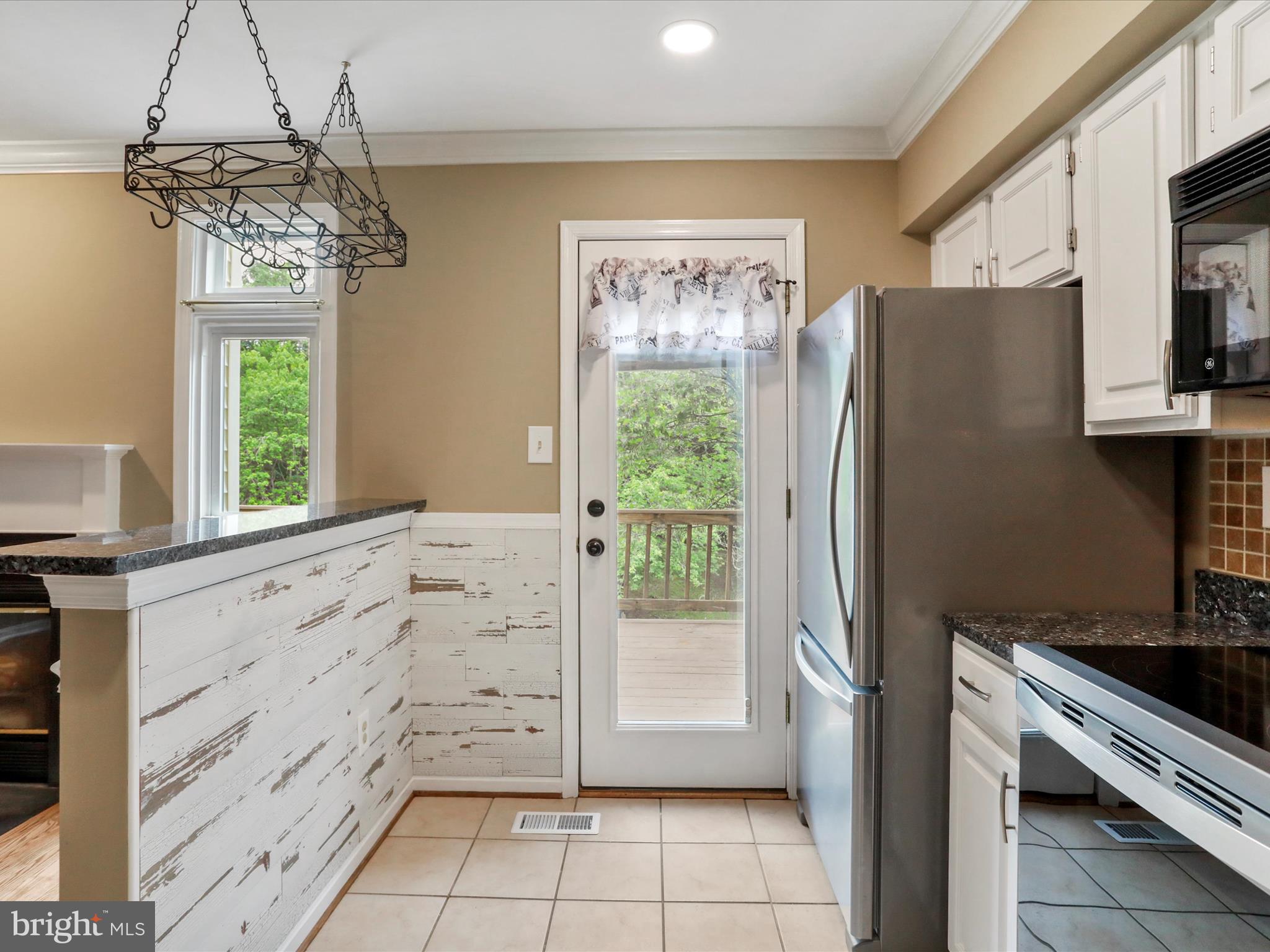 6910 Compton Valley Court Centreville, VA 20121 - Photo 14 of 37 a kitchen with granite countertop a refrigerator and a stove top oven