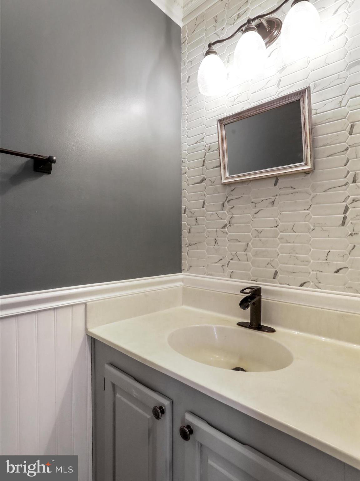 6910 Compton Valley Court Centreville, VA 20121 - Photo 18 of 37 a bathroom with a sink and a mirror