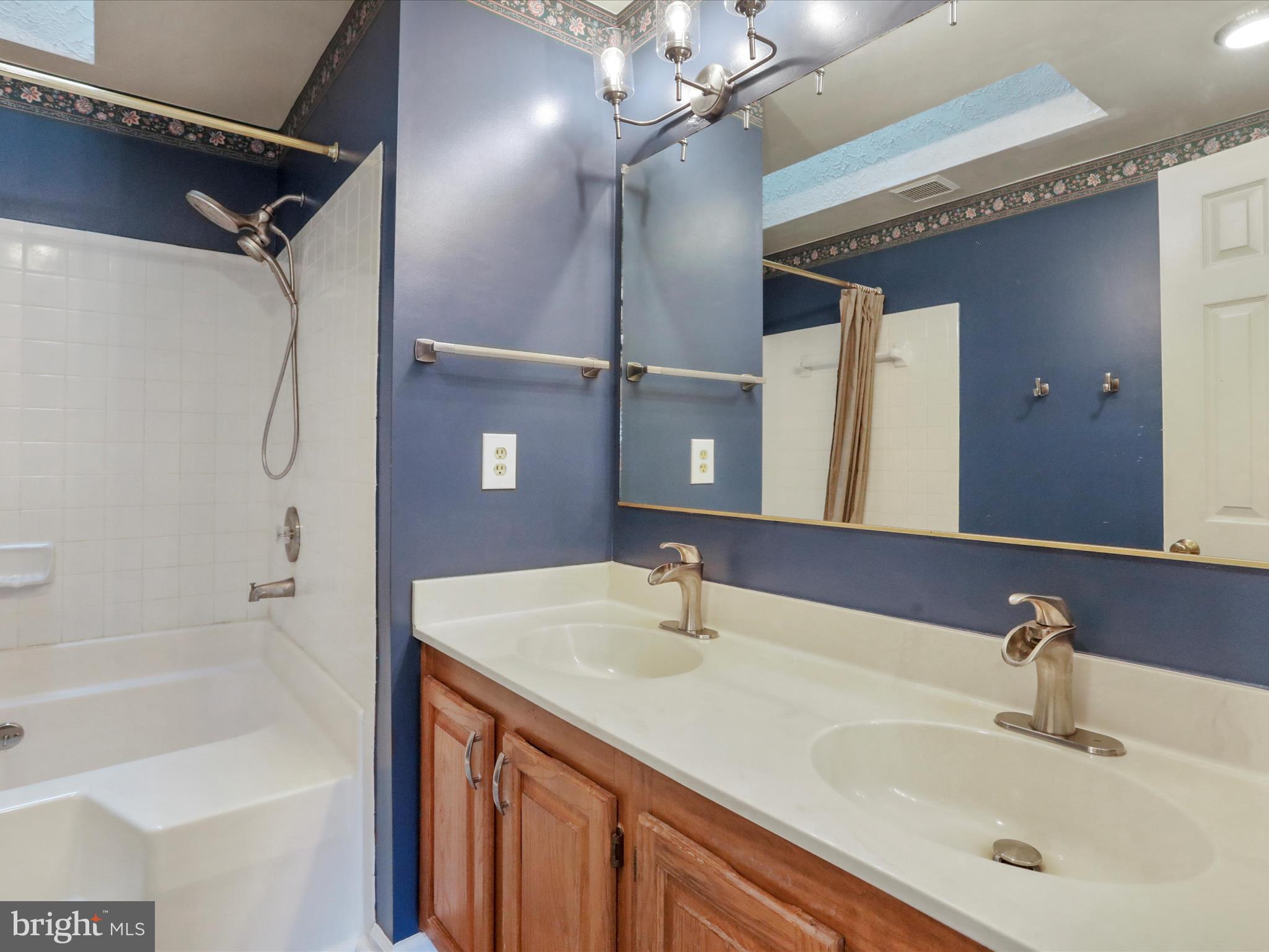 6910 Compton Valley Court Centreville, VA 20121 - Photo 26 of 37 a bathroom with a sink vanity tub and a mirror