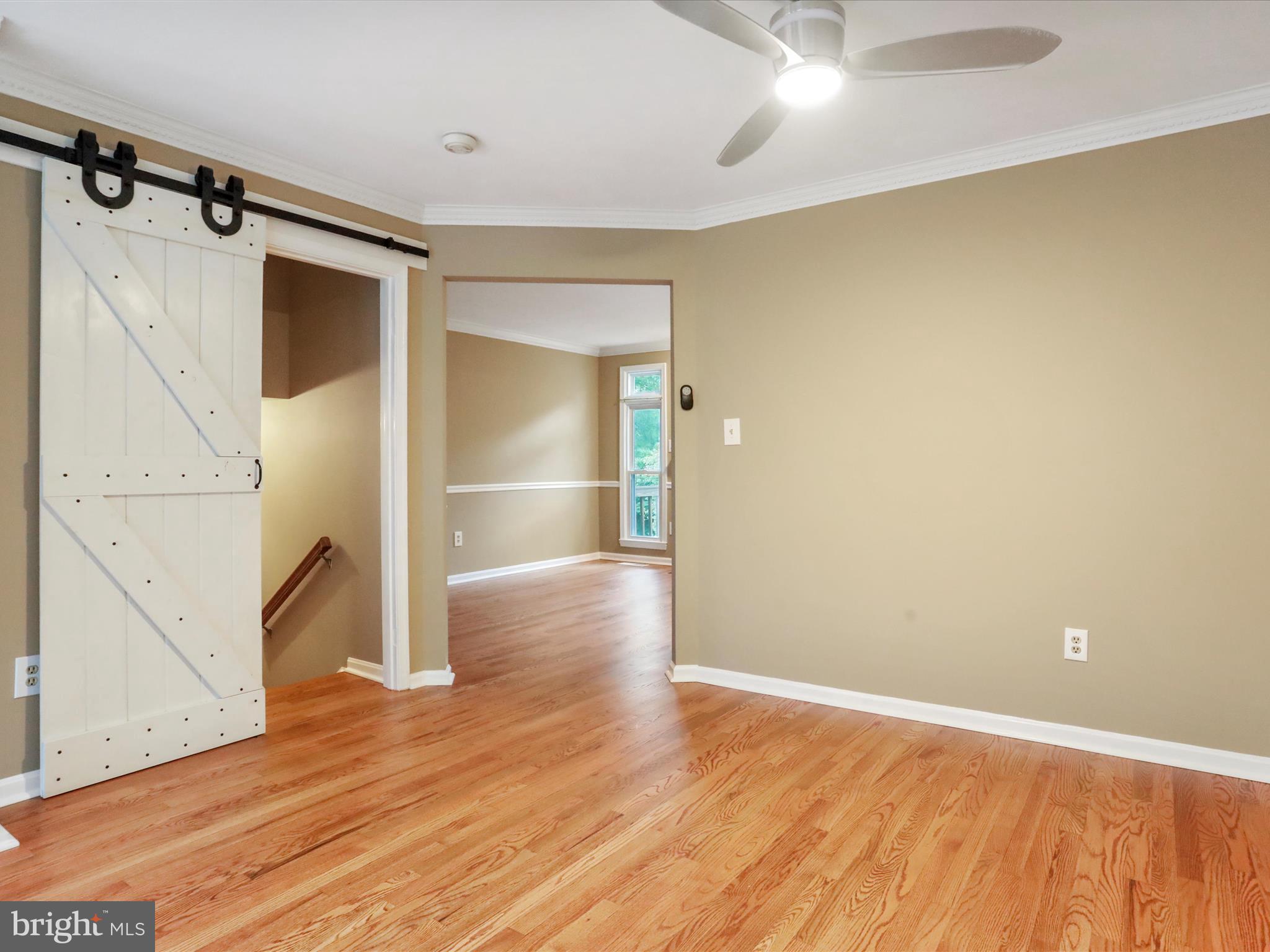 6910 Compton Valley Court Centreville, VA 20121 - Photo 4 of 37 a view of empty room with wooden floor and fan