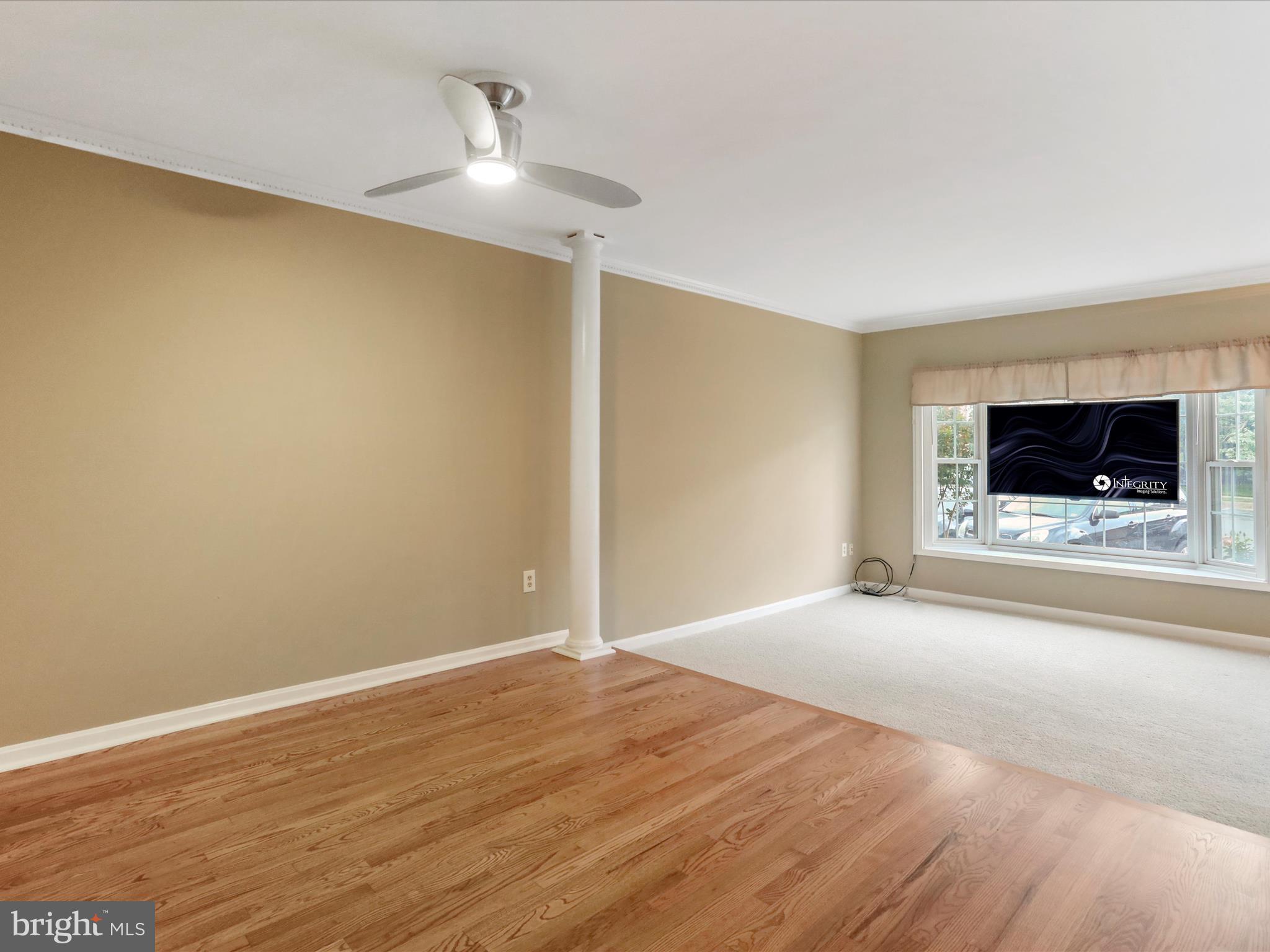 6910 Compton Valley Court Centreville, VA 20121 - Photo 7 of 37 a view of an empty room with wooden floor and a kitchen