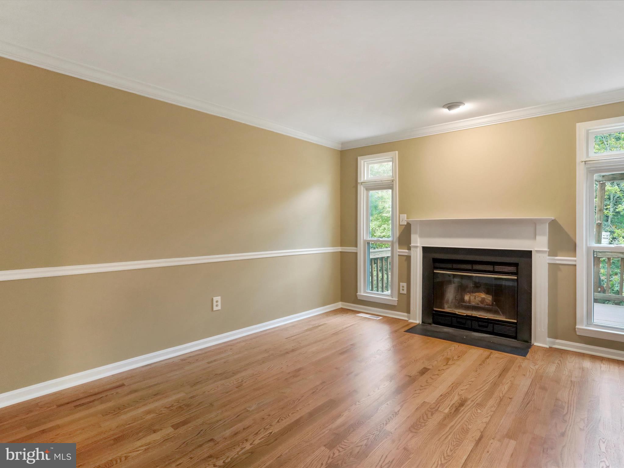 6910 Compton Valley Court Centreville, VA 20121 - Photo 9 of 37 a view of an empty room with wooden floor fireplace and a window