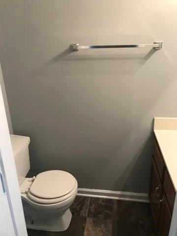 a bathroom with a toilet and a shower view